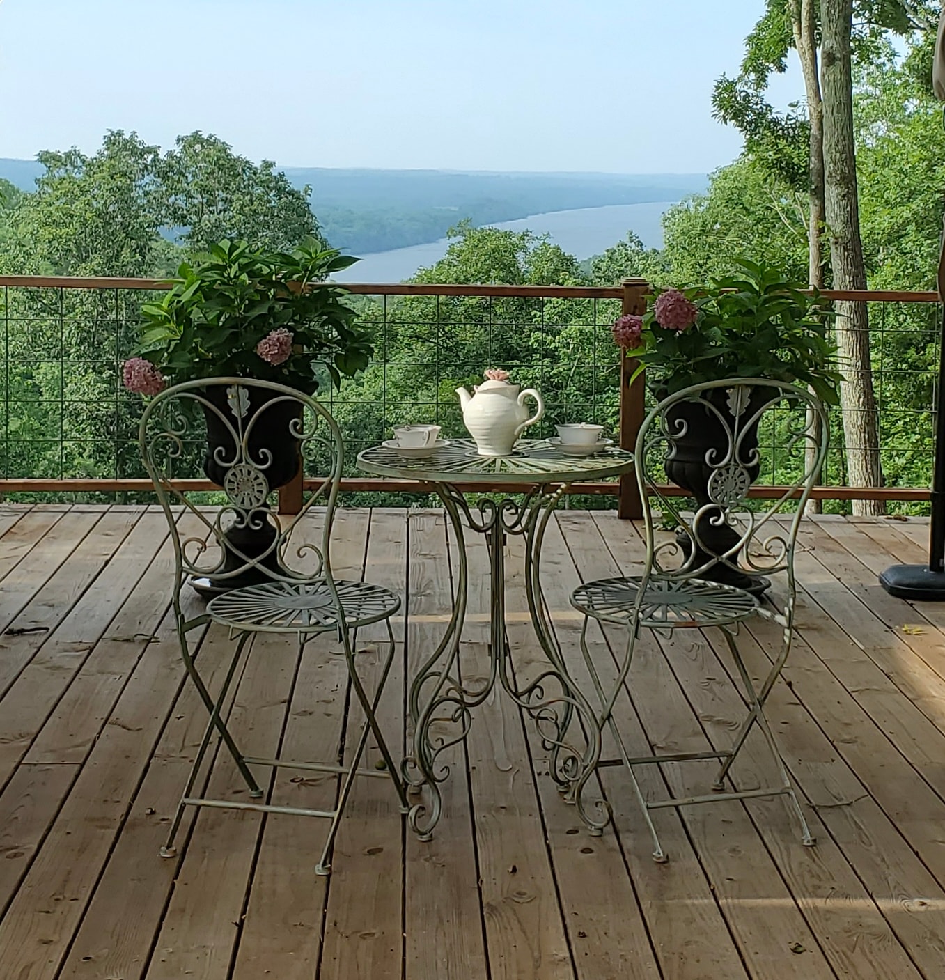 Pavilion deck with ornate chairs overlooking the river